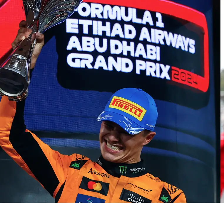 Lando lifting Abu Dhabi trophy